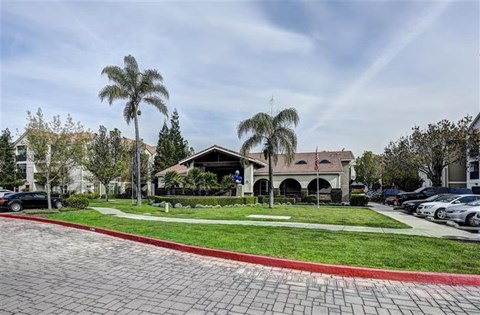 A building with a red brick walkway in front of it.