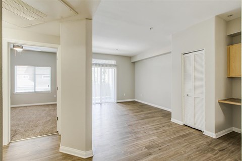 A room with a carpeted floor and a window.