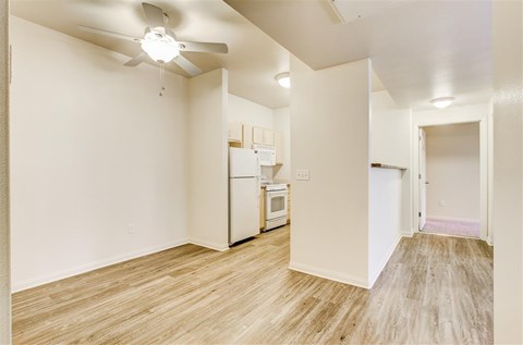 A kitchen area with a refrigerator, microwave, and oven.