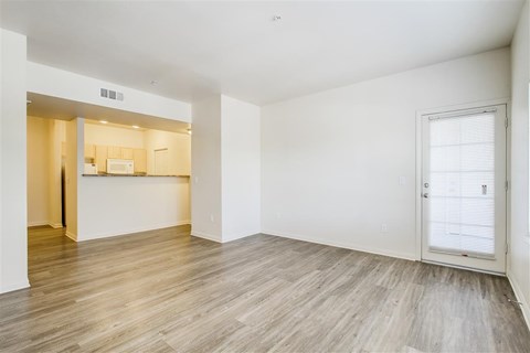 A room with a white wall and a wooden floor.