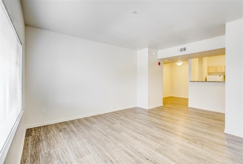 A room with wooden flooring and white walls.