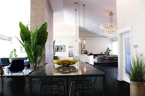 A modern kitchen with a black table and chairs.