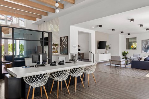 A modern home office with a desk and chairs.