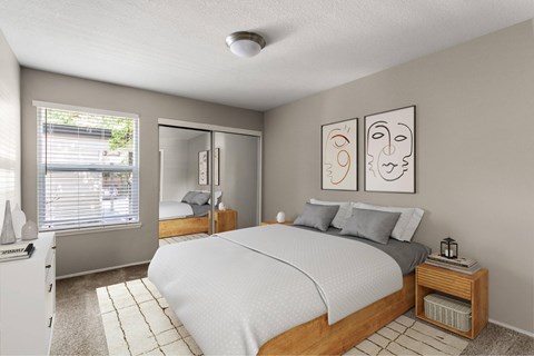 A bedroom with a bed, nightstand, and two framed pictures on the wall.