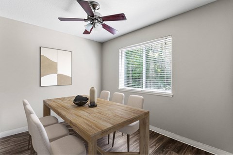 A dining room with a wooden table and chairs.