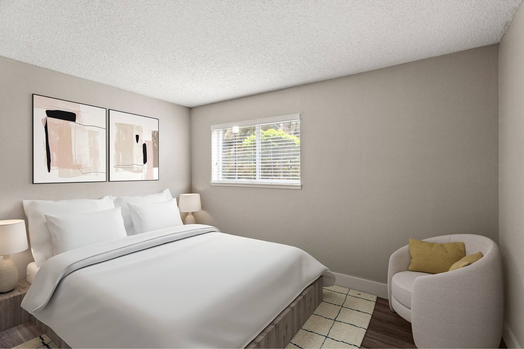 A bedroom with a large bed and a yellow chair.