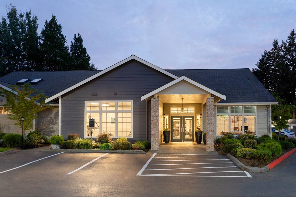 A building with a parking lot in front of it.