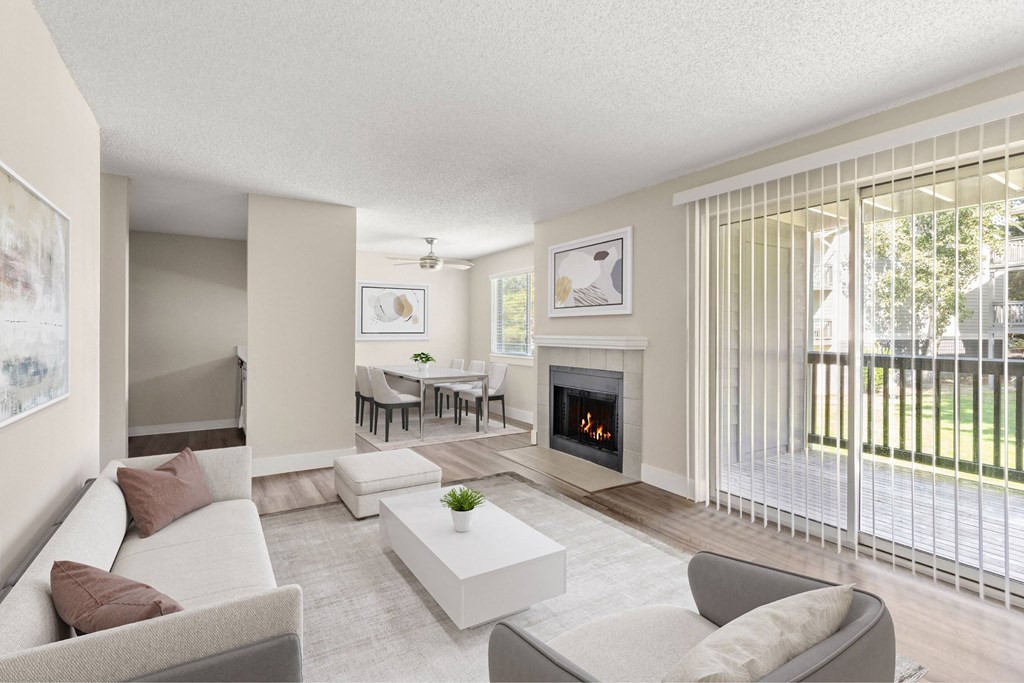 A living room with a fireplace and a dining table.