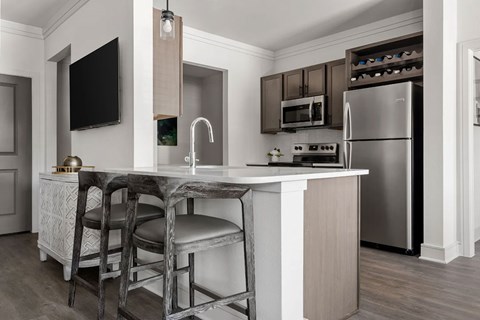 A kitchen with a bar stool and a countertop.