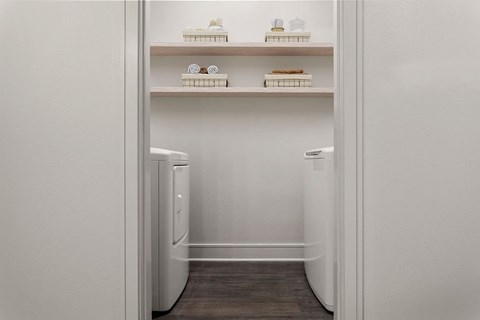 A white refrigerator with a drawer and shelves inside.