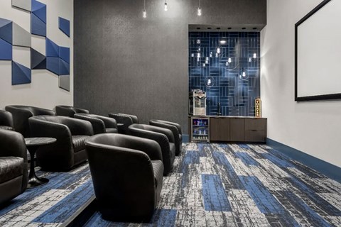 A room with black chairs and a blue carpet.
