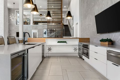 A modern kitchen with white cabinets and a central island.