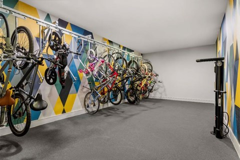 A bike rack with bikes of various types and sizes.