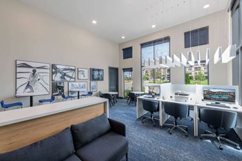 A modern office space with a long reception desk and multiple workstations.