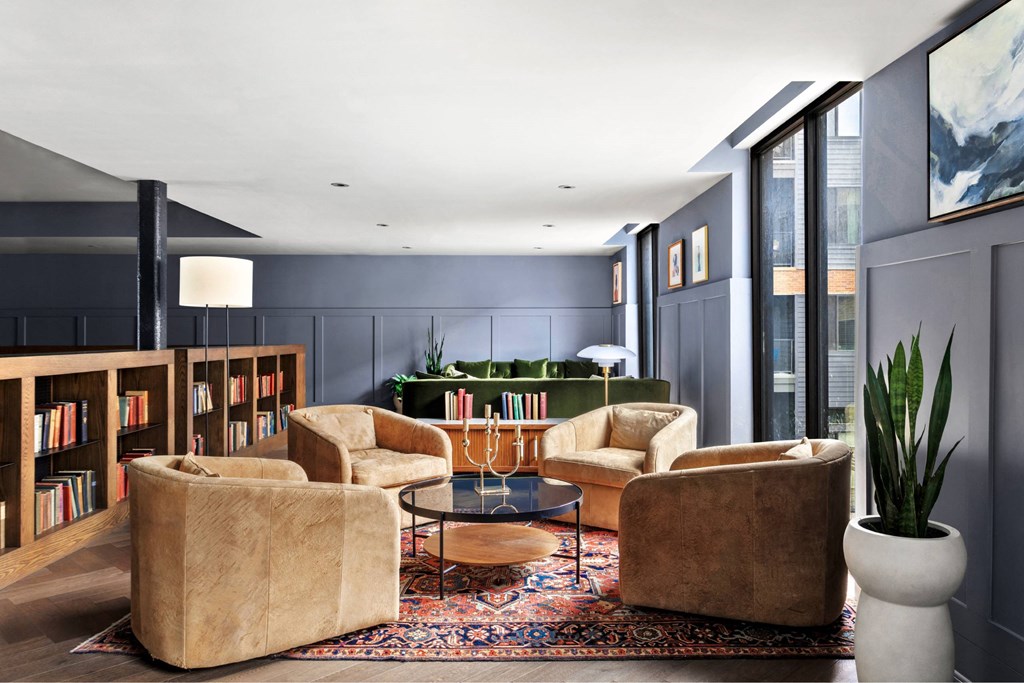 A living room with a large rug and a coffee table.