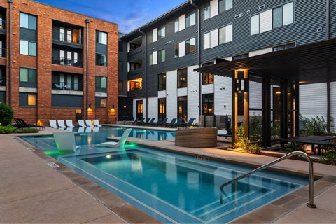 A swimming pool in front of a modern building.