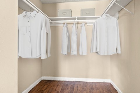 A row of white shirts hanging on a rack.