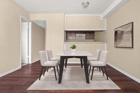 A dining room with a table and chairs.