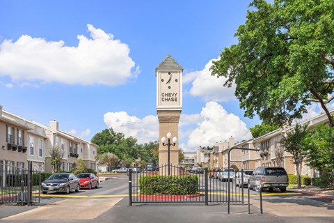 A clock tower in the middle of a street with a sign that says "Cherry Chase".