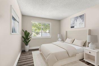 A bedroom with a large bed, two lamps, and a potted plant.