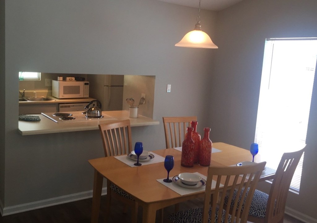 A dining room with a table set for two.