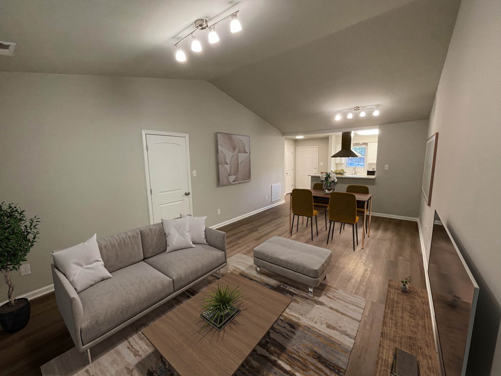 A living room with a grey couch and a wooden coffee table.