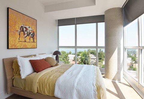 Bedroom with large windows and city views at 929 Richmond Apartments, Ottawa, Ontario