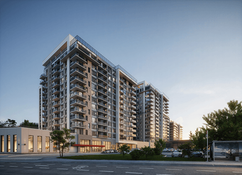 A modern apartment building with a parking lot in front.