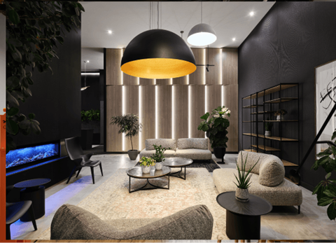 A modern living room with a large grey sofa and a coffee table.