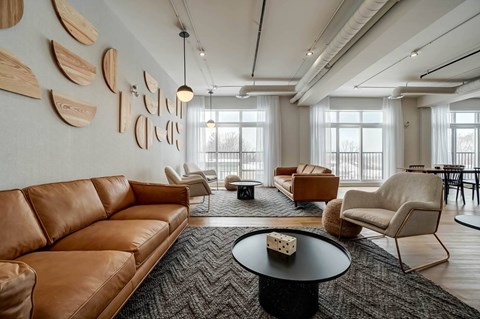 A living room with a brown leather couch and a coffee table.