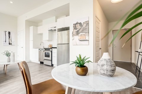 A modern kitchen with a dining table and chairs.