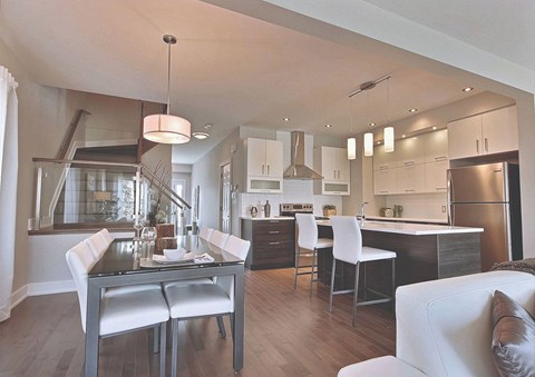 A modern kitchen with a dining table and chairs.
