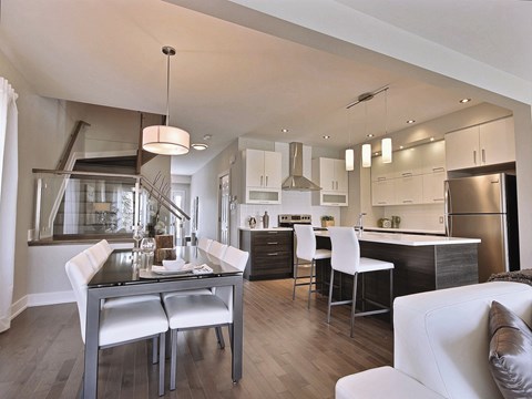 A modern kitchen with a dining table and chairs.