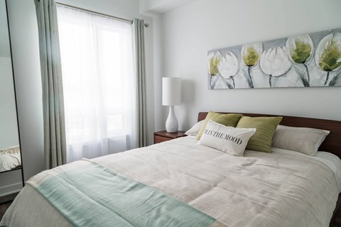 Bedroom with natural light and modern decor at Kanata Lakes Apartments, Ontario