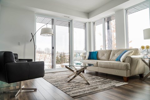 Modern living room with floor to ceiling windows at Kanata Lakes Apartments, Ontario, K2T 0K3