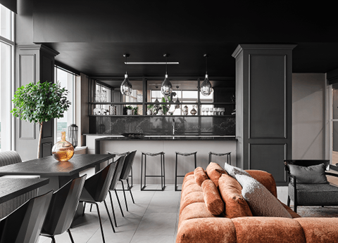 A modern kitchen with a dining table and chairs.