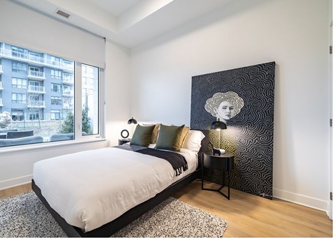 Modern bedroom with artistic wall decor at Petries Landing II Apartments, Ontario