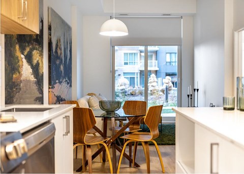 A modern kitchen with a dining table and chairs.