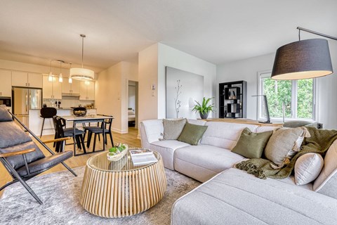 A modern living room with a white couch and a wooden coffee table.