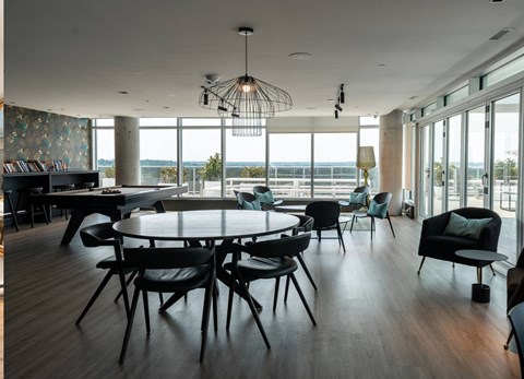 A modern dining room with a large table and chairs.