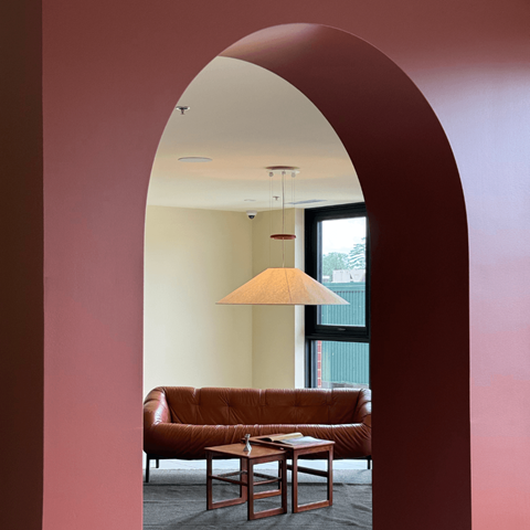 A living room with a brown couch and a table.