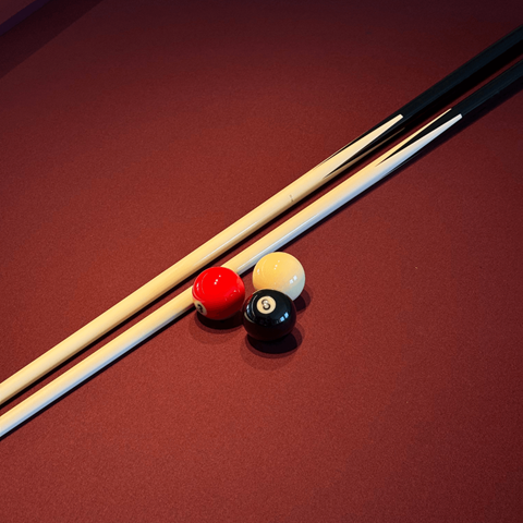 Three pool balls are lined up on a pool table.