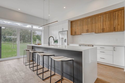 A kitchen with a bar area and a sink.