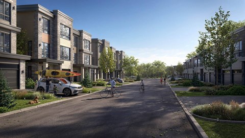 A street view of a residential area with apartment buildings on both sides and people walking and riding bikes.