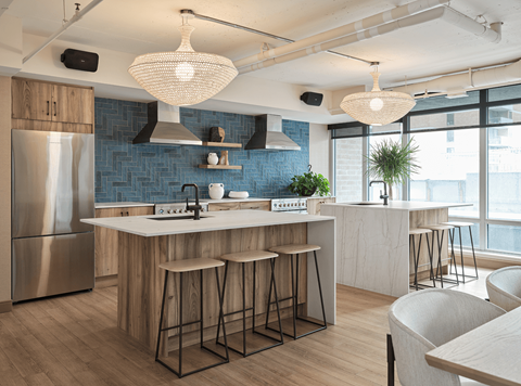 A modern kitchen with a large island and bar stools.