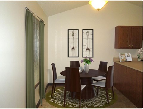 A dining room with a table set for six.