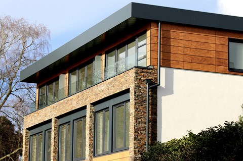 A modern house with a combination of brick and wood siding.
