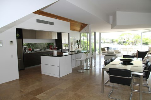 A modern kitchen with a dining table and chairs.