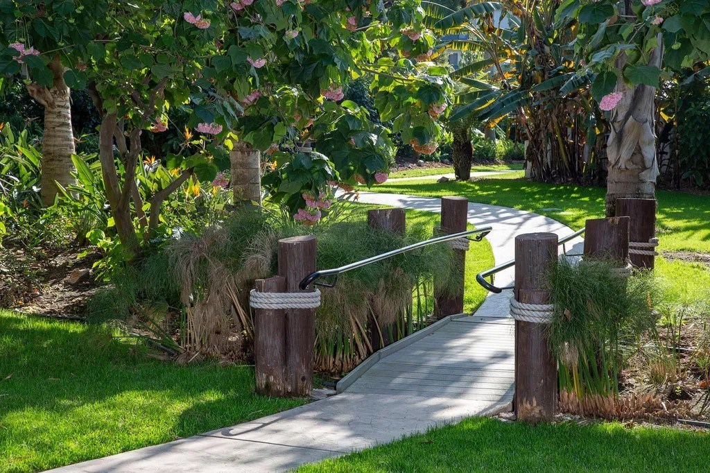 A pathway with a rope barrier and wooden posts.