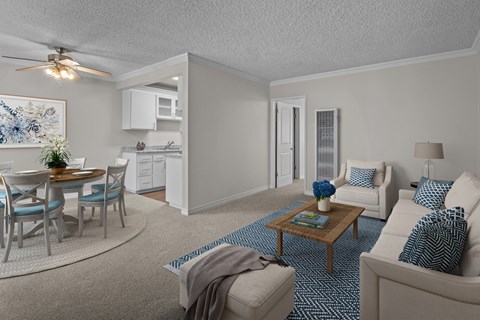 A living room with a dining table and chairs.